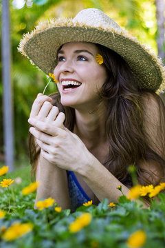 Attractive woman smelling flower