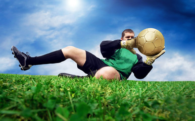 Fototapeta na wymiar Jump of football goalman on the outdoor field