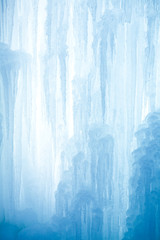 A frozen waterfall with ice in a blue and white color in winter - 18476044