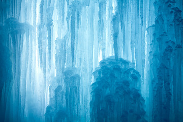 A frozen waterfall with ice in a blue and white color in winter - 18476067