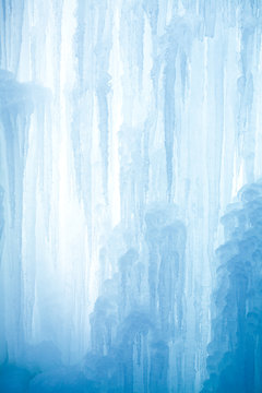 Naklejki A frozen waterfall with ice in a blue and white color in winter
