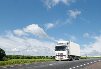 white truck on  country highway under blue sky