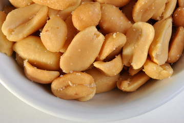 roasted salted peanuts in a white bowl