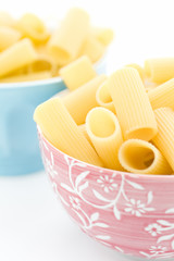 Raw pasta in bowls