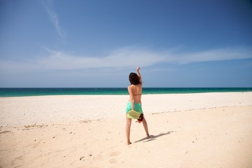 Fototapeta na wymiar barefoot woman dance at beach