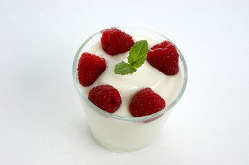some organic raspberries in natural yogurt and mint