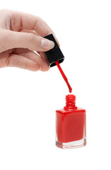 Fototapeta premium Hand with tassel and red varnish for nail