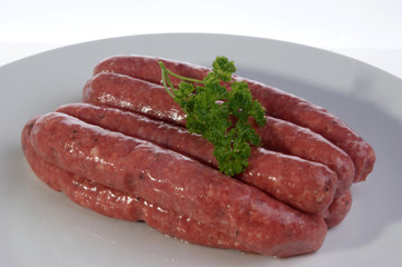 pork black pepper sausages on a white plate