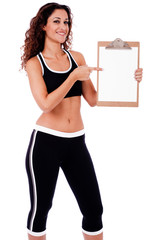 Fitness woman showing a blank clip board