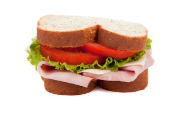 A ham sandwich on wheat on a white background