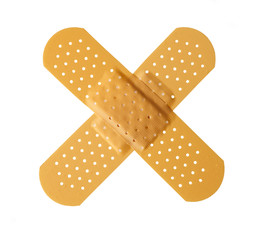 Two bandages forming a cross shape isolated on white