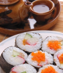 Japanese traditional food sushi with tea pot as background