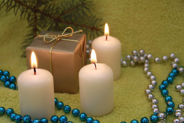 Christmas candles on green background