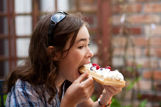 Kid Eating Cake With Cream And Fruits