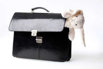Black suitcase with white rabbit isolated  on white background