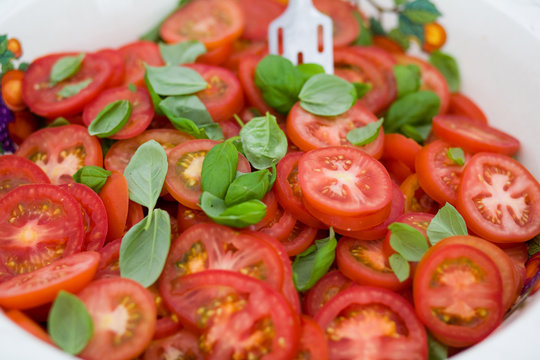 tomatoes and basil in a bowl at a catered event