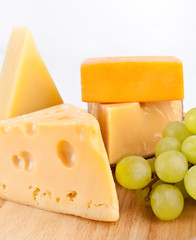 Various types of cheese with white grapes