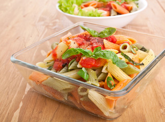 colored penne pasta with tomato sauce and basil