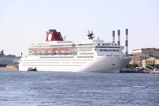luxury white cruise ship shot at angle at water level