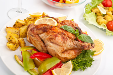 whole grilled chicken garnished with vegetables
