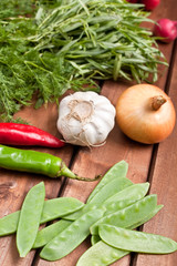 vegetables and greens on wooden table