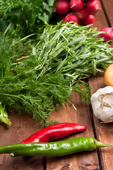 vegetables and greens on wooden table