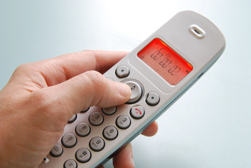 hand dialing the phone with shallow background