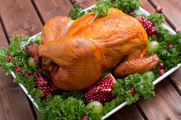 roasted chicken garnished with parsley and fruits