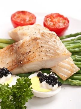 healthy fish with asparagus, tomatoes and caviar