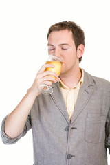 Young man drinking beer on white background