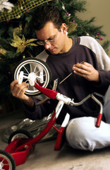 Dad assembling tricycle - obrazy, fototapety, plakaty