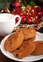 Fototapeta na wymiar christmas chocolate chip cookies with milk and decorations