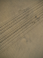 tire treads track in sand