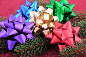 Assorted Christmas Bows Laid On a Evergreen Branch