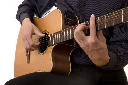 man plays acoustic guitar