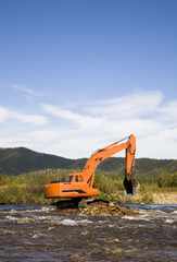 excavator dredging sediment mud from river