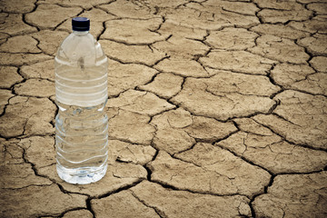 Water bottle on dry ground