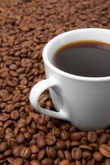 Cup with coffee, costing on coffee grain