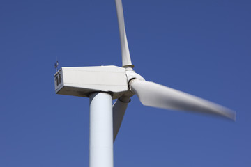 wind turbines renewable power over a blue sky