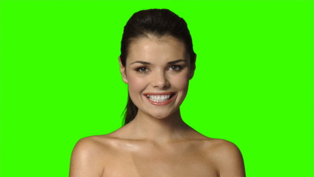 Beautiful and sexy woman is smiling on green screen