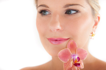 Young woman with healthy skin and orchid flower