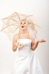 Young sexy bride with umbrella under the rain