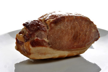 cooked organic back bacon joint on a plate