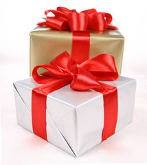 Gifts in silver and gold wrapping with red bow