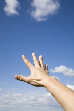 Hand reaching up to  the sky