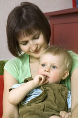 mother cuddle her blond baby