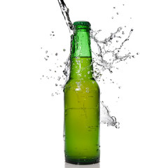Green beer bottle with water splash isolated on white