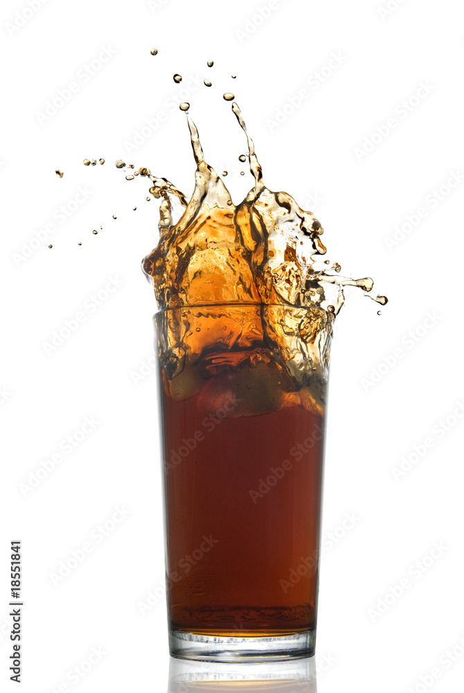 Wall mural Beautiful splash of cola in glass isolated on white