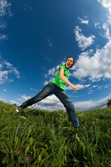 Girl jumping outdoor against blue sky