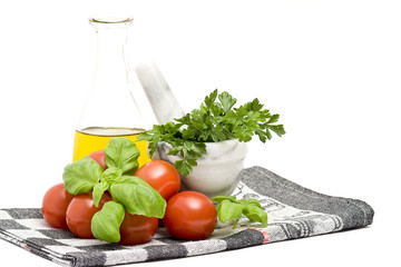 bottle of olive oi, tomatoes, basil and parsley